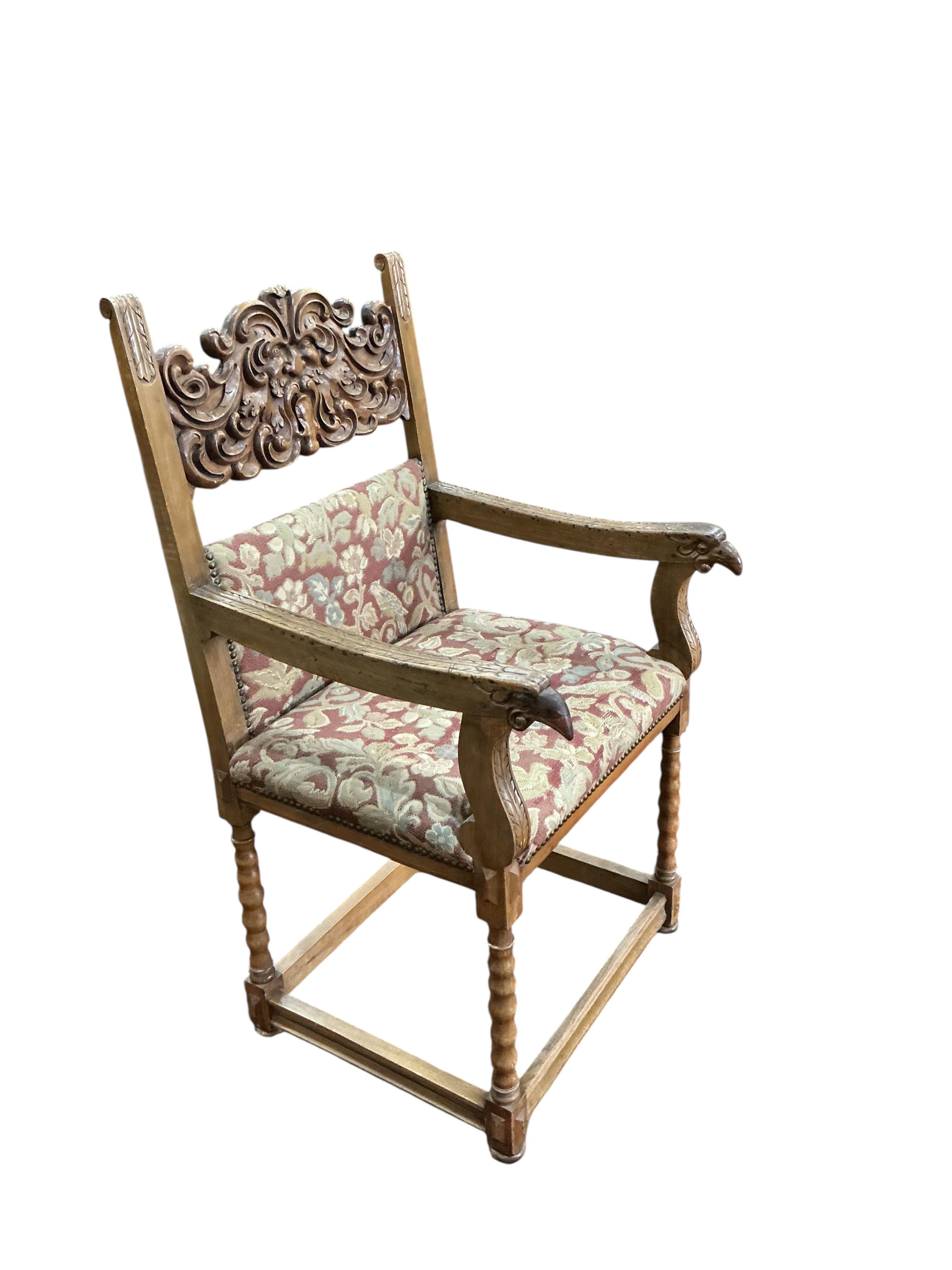An 18th century style carved walnut elbow chair, width 56cm, depth 54cm, height 111cm